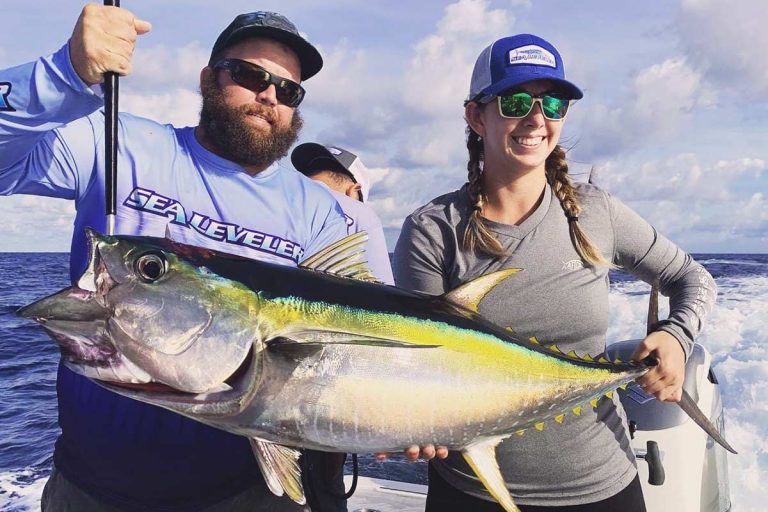 Couple Holding Big Yellow Fin Fish on Boat