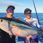 Two Man Holding Tuna Fish on Boat